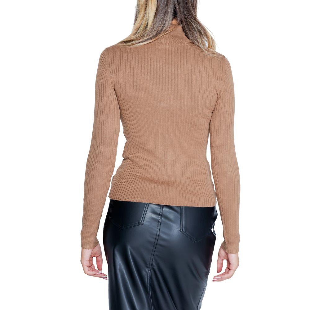 Back view of woman in Jacqueline De Yong Brown Viscose Sweatshirt with roll neck and long sleeves, paired with a black skirt.
