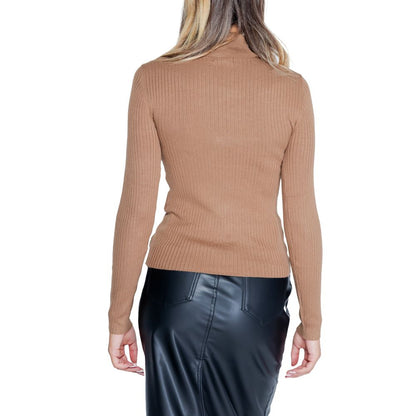 Back view of woman in Jacqueline De Yong Brown Viscose Sweatshirt with roll neck and long sleeves, paired with a black skirt.