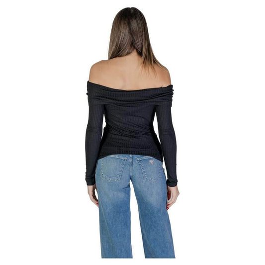 Back view of a woman wearing a black off-the-shoulder Jacqueline De Yong Viscose top with blue jeans. Ideal for fall/winter style.
