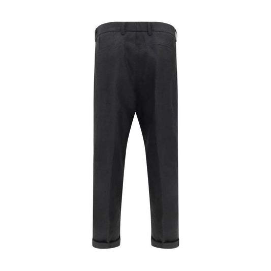 Back view of Dolce & Gabbana linen pants with tailored design and balloon leg silhouette, featuring welt pockets, zipper and button closure.