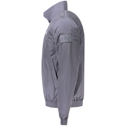 Side view of a Calvin Klein Blue Polyamide Men Jacket with zip closure and logo patch on sleeve.