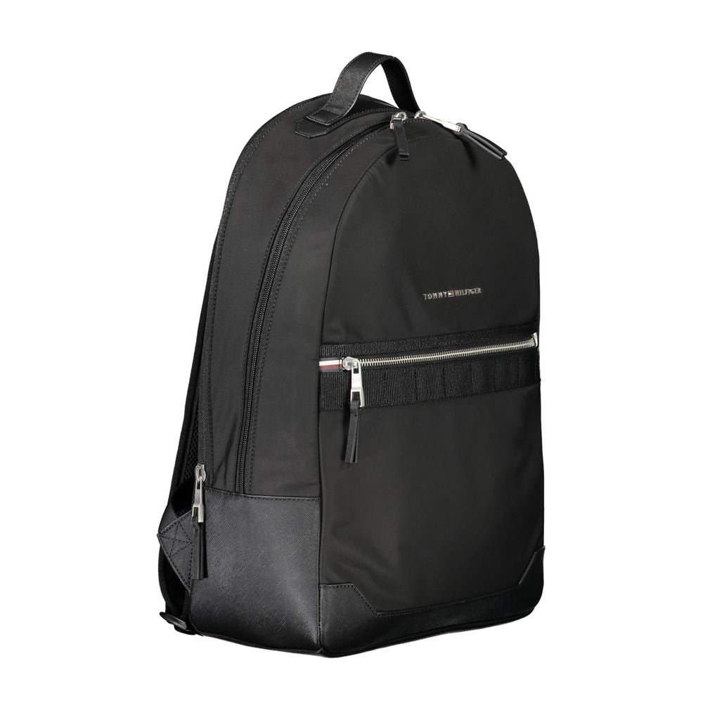 Tommy Hilfiger Black Polyester Backpack with adjustable straps and zip closure, featuring a front pocket and internal laptop compartment.
