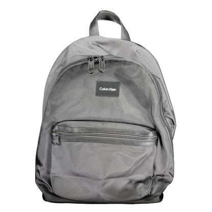 Calvin Klein Black Polyester Backpack with handle, adjustable straps, external and internal pockets, laptop compartment, eco-friendly material.