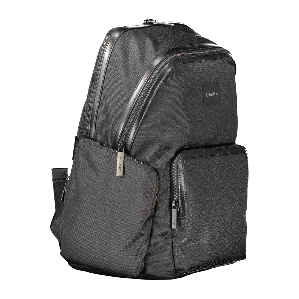 Calvin Klein Black Polyester Backpack with multiple pockets and contrasting details, featuring logo and adjustable straps.