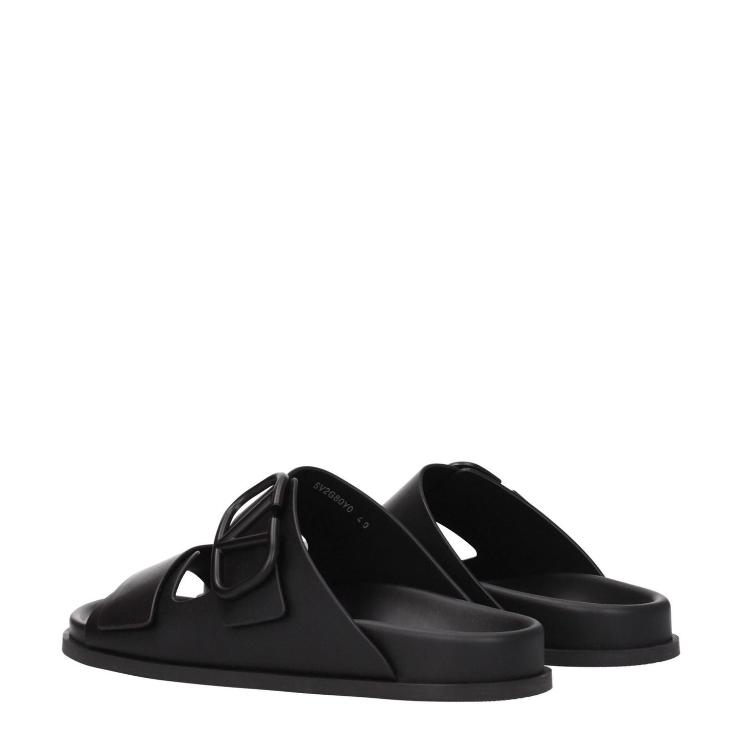Valentino Garavani Black Leather Slippers with open toe and front logo, featuring a low flat heel and rubber sole, perfect for casual wear.