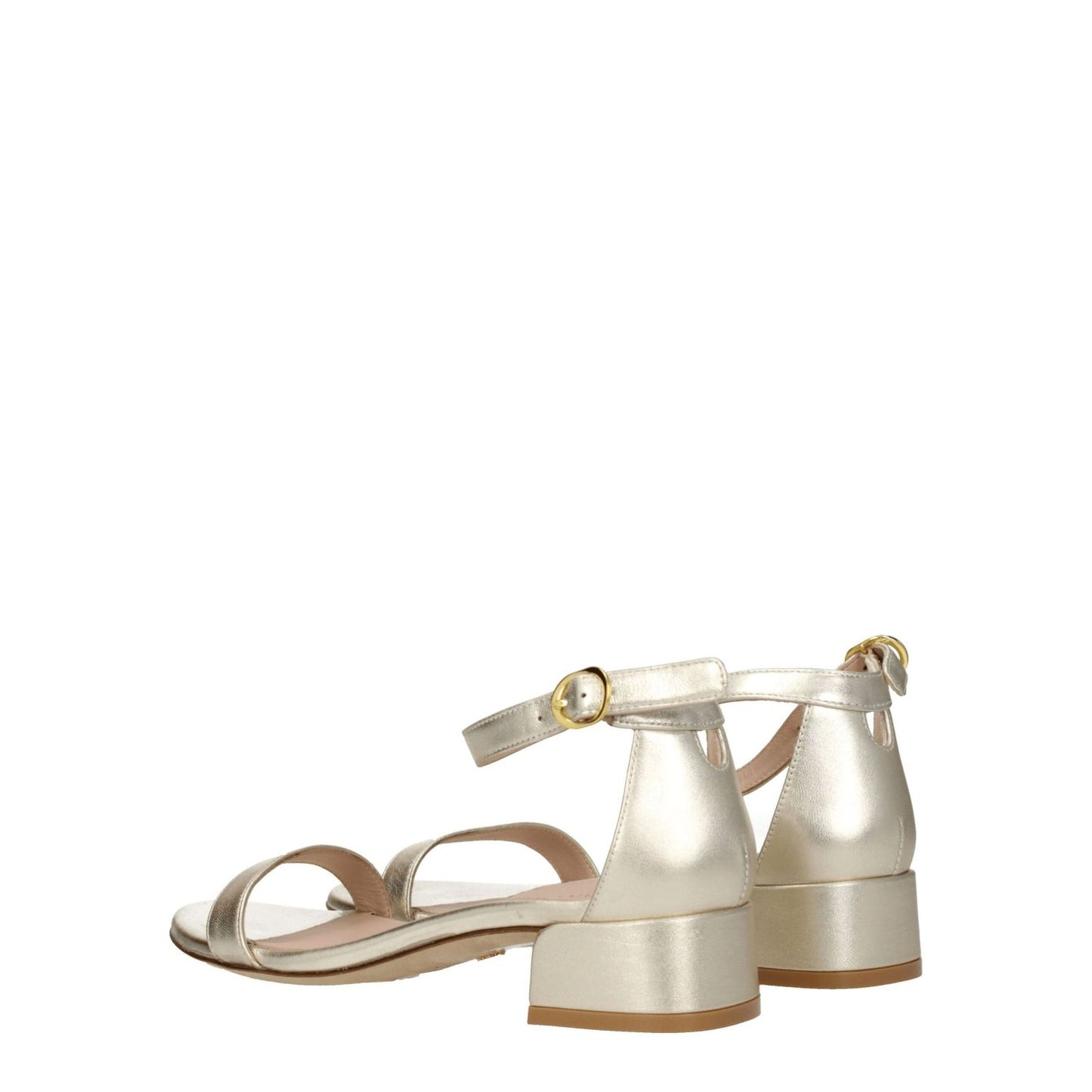 Stuart Weitzman Gold Leather Flat Sandals with buckle closure and mid heels, featuring a metallic platinum color and open toe design.