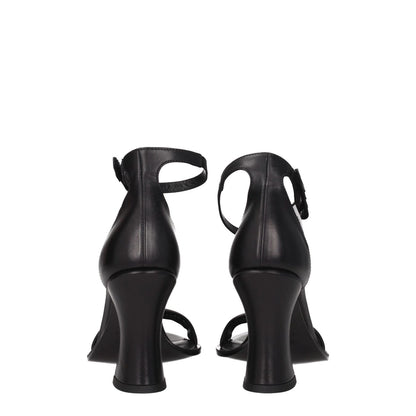 Rear view of Premiata Black Leather Flat Sandals with buckle closure and high heel, showcasing vintage effect and side logo.