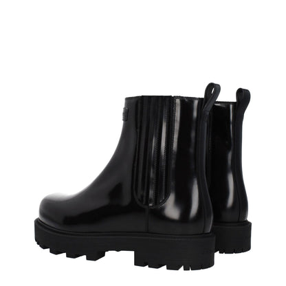 Givenchy Black Leather Ankle Boots with front and back logo, rubber sole, and round toe, featuring mid heels and casual style.
