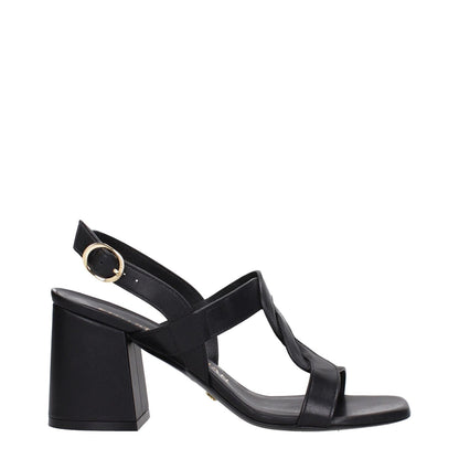 Stuart Weitzman Black Leather Platform Sandals with mid heel and open toe, featuring a buckle closure and leather sole.