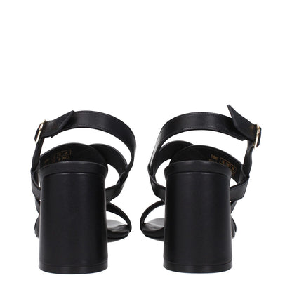 Stuart Weitzman Black Leather Platform Sandals with buckle closure and open toe, featuring mid heels and leather sole, rear view.