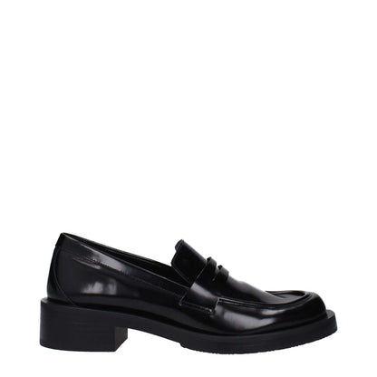 Stuart Weitzman Black Leather Slip-On Loafers with round toe and mid heels, featuring rubber sole and stylish design.