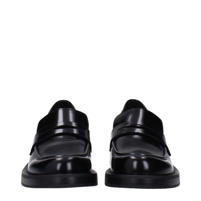 Stuart Weitzman Black Leather Slip-On Loafers with round toe and mid heels, featuring a rubber sole. MPN: PALMERAPSSG649BLACK.