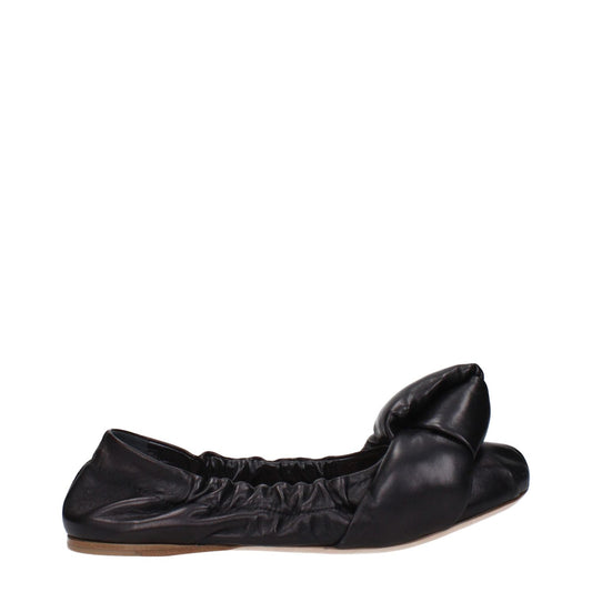 Side view of Miu Miu Black Leather Ballet Flats with low heel and front detail, featuring a round toe design and leather sole.