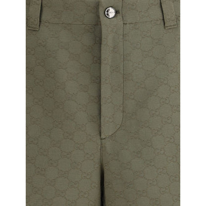 Close-up of Gucci Green Cotton Bermuda Shorts with GG pattern, front zipper, and button closure, showcasing the iconic monogram design.
