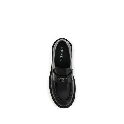 Prada Black Calf Leather Bos Taurus Slip-On Loafers with enameled metal triangle on top view.