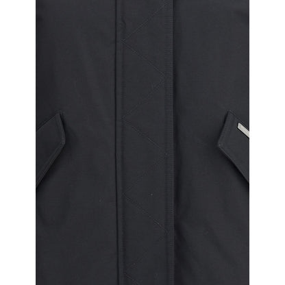 Close-up of Woolrich Black Cotton Shell Jacket showing front closure and welt pockets with flaps for winter AW25 season.