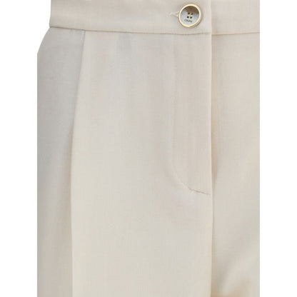 Close-up of Cruna Cream Polyester Casual Pants with button fastening and side pocket detailing.