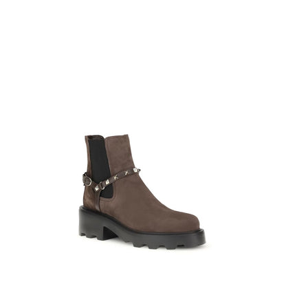 Valentino Garavani Brown Calf Leather Bos Taurus Chelsea Boots with studs and strap, rounded toe, and lug sole.