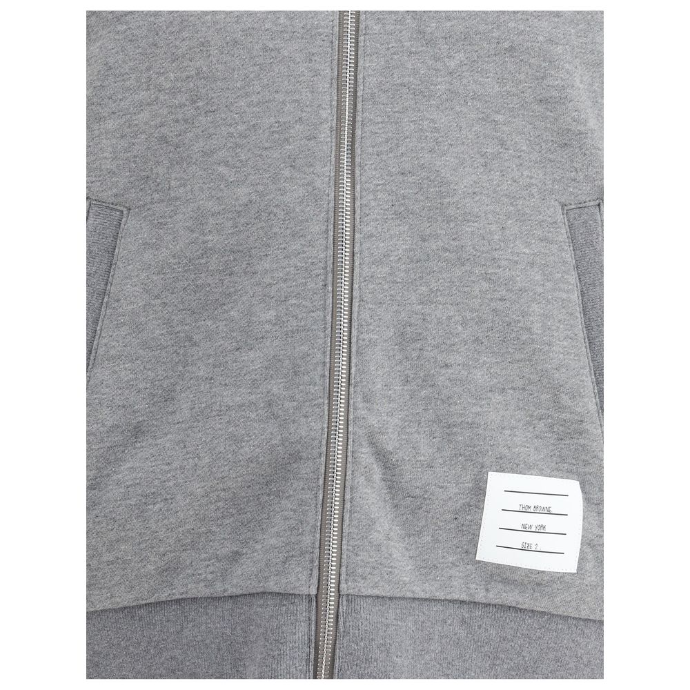 Thom Browne Gray Cotton Sweatshirt with front zipper, logo patch, and signature sleeve bands, showcasing stylish and comfortable design.
