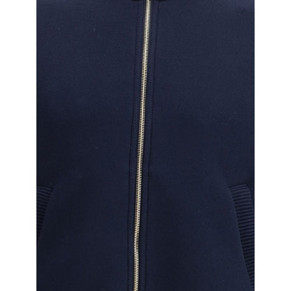 Front view of Thom Browne Blue Cotton Bomber jacket showcasing zipper and tricolor details, perfect for a modern refined look.