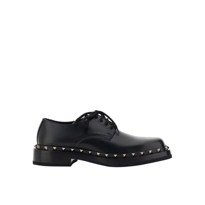 Valentino Garavani Black Calfskin Oxfords And Derbies with studs, leather sole and lace-up closure for men, made in Italy.