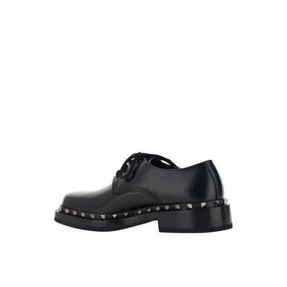 Valentino Garavani Black Calfskin Oxfords And Derbies with round toe and studs detail, men's leather shoes made in Italy.