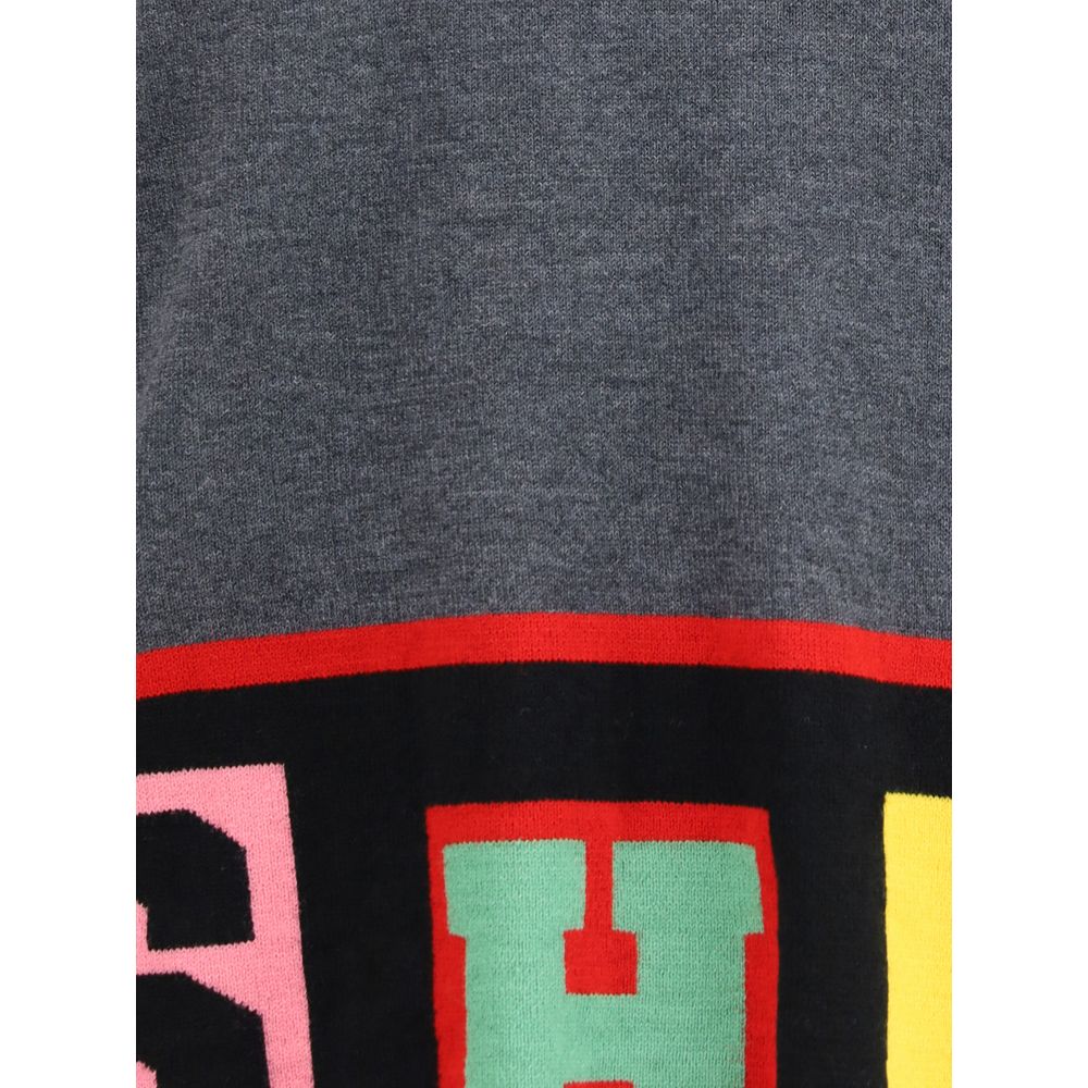 Close-up of Comme Des Garçons Gray Marabou Sweatshirt showcasing colorful lettering detail on a gray fabric.