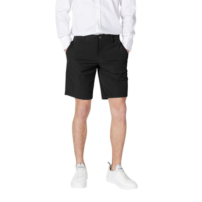 Man wearing Armani Exchange Black Polyamide Bermuda Shorts with white shirt and sneakers.