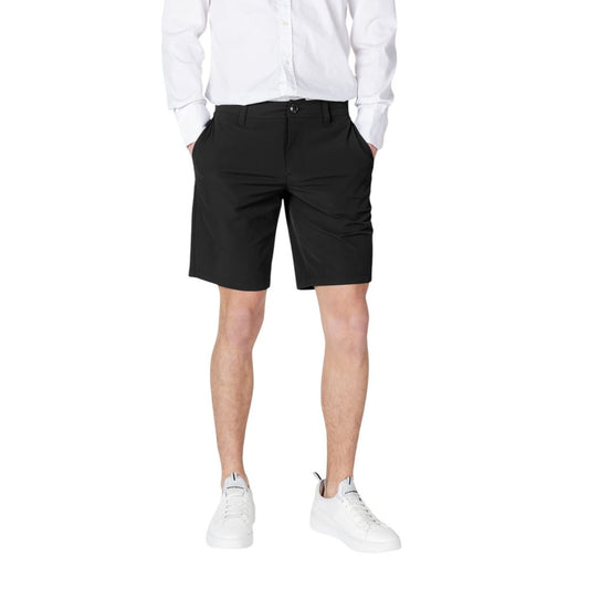 Man wearing Armani Exchange Black Polyamide Bermuda Shorts with white shirt and sneakers.