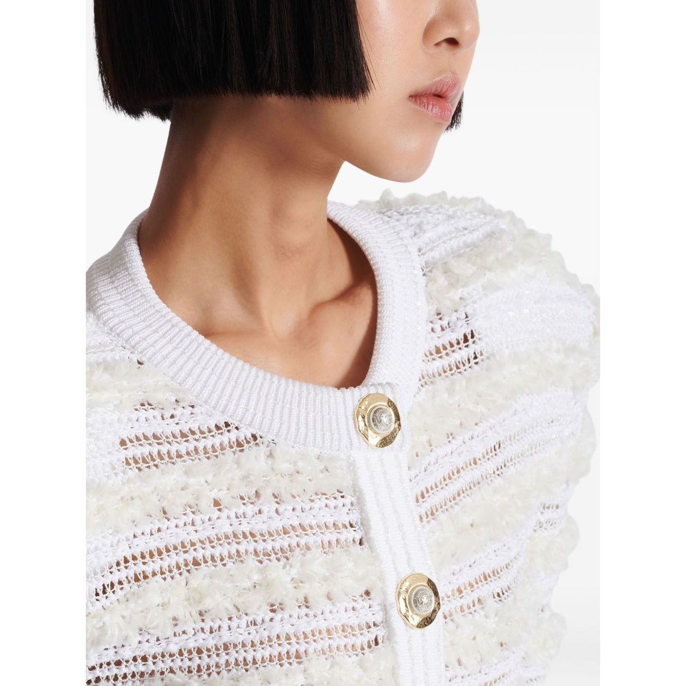 Balmain Long-sleeved tweed-effect knit cardigan with white button fastening, pinched shoulders, and ribbed crew neck.