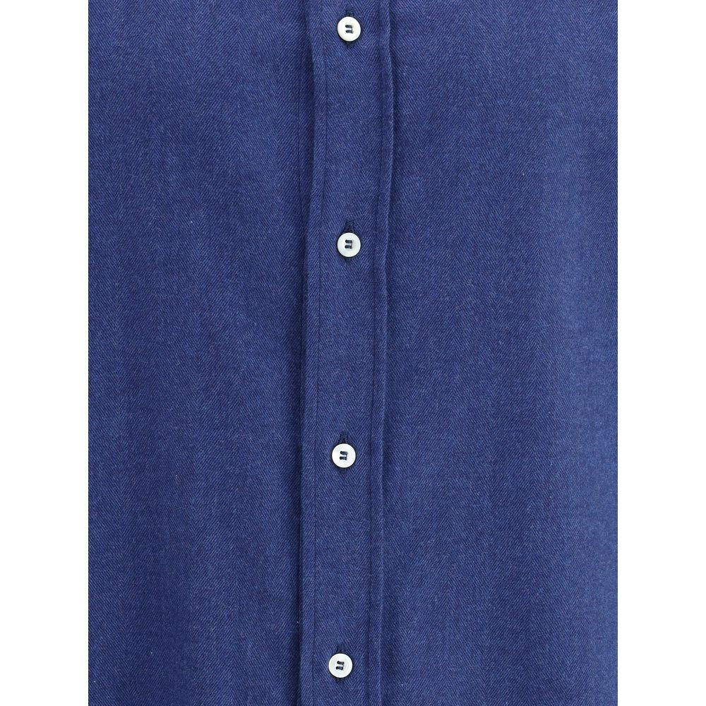 Brunello Cucinelli Blue Cotton Dress Shirt with front button closure and monochrome pattern, showcasing classic and versatile elegance.