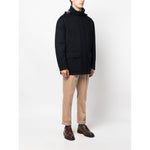 Brunello Cucinelli Detachable hood padded coat in midnight blue cashmere with drawstring hood and pockets, modeled with beige trousers.