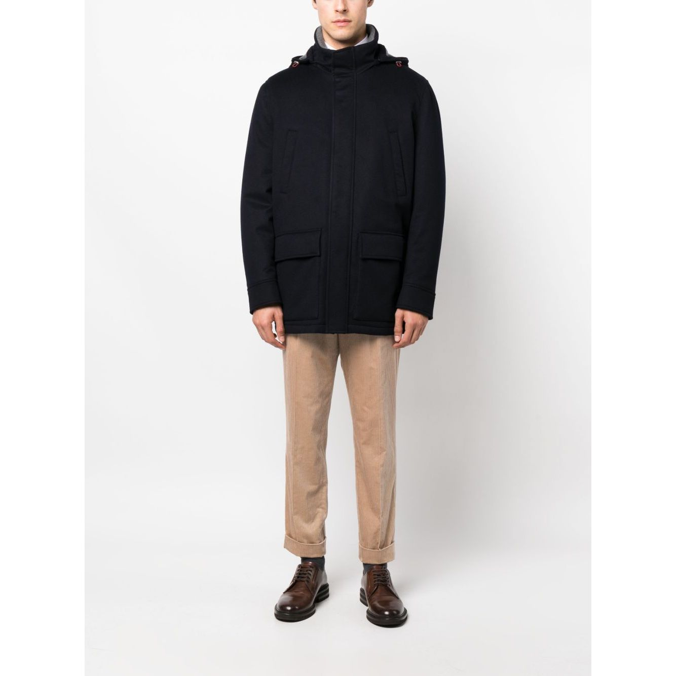 Brunello Cucinelli Detachable hood padded coat in midnight blue with stand-up collar and pockets on male model.