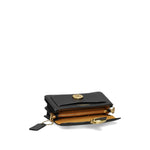 Black Coach Tabby 20 leather crossbody bag open showing multifunctional pockets and snap closure with removable shoulder strap.