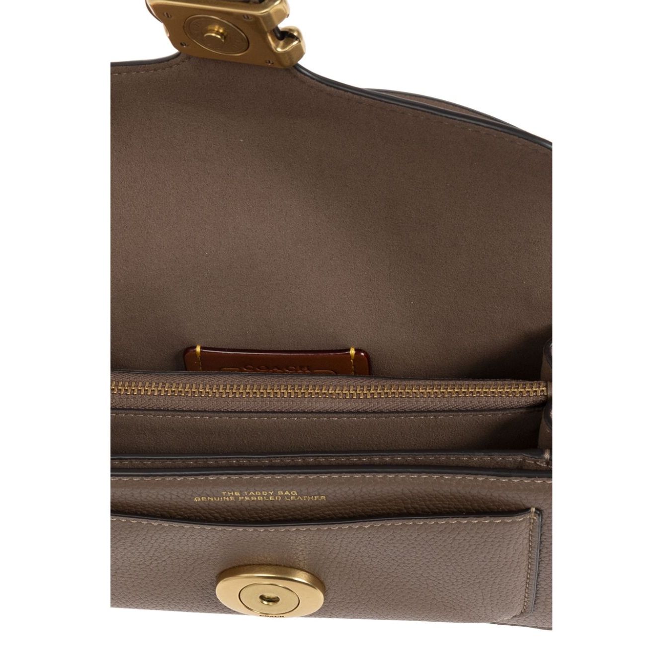 Interior view of Coach Tabby 20 shoulder bag showcasing multifunctional internal pockets with zip and fabric lining.