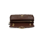 Interior view of the Coach Tabby 26 Shoulder Bag in chestnut brown quilted nappa leather with magnetic fastening and zip pocket detail.