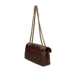 Coach Tabby 26 Shoulder Bag in chestnut brown nappa leather with quilted design and chain-link strap, side view.