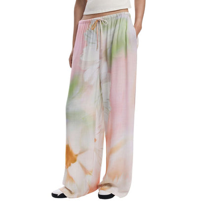 Woman wearing Desigual Multicolor Viscose Bottoms Sleepwear with pink floral pattern and lace fastening, perfect for spring/summer.