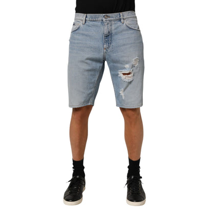 Dolce & Gabbana Blue Cotton Distressed Denim Bermuda Shorts showing front view with distressed details.