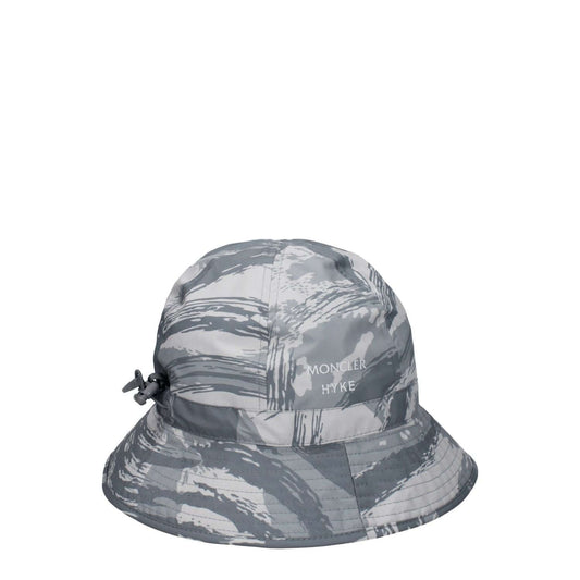 Moncler Gray Polyester Bucket Hat with front logo and drawstring closure, made entirely of 100% polyester. Sporty glam style.