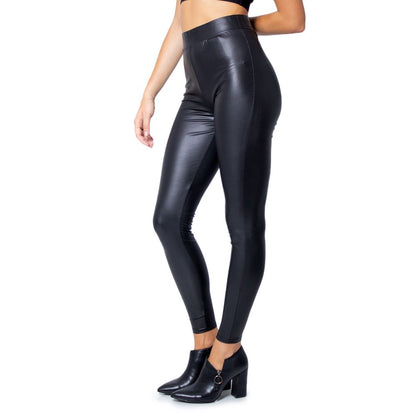 Woman wearing Only Black Polyester Leggings with a glossy finish, showcasing fitted design and stretchy fabric for stylish comfort.