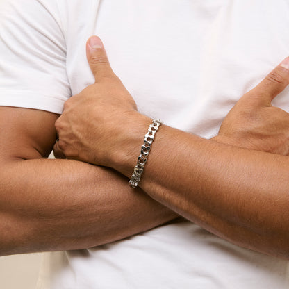 Man wearing silver bracelet RADIANT JEWELS JEWELRY Mod. RH000328, showcasing elegant design on crossed arms.