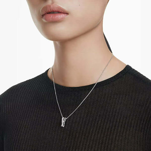 Swarovski necklace on a woman wearing a black top, showcasing elegant and minimalist design.