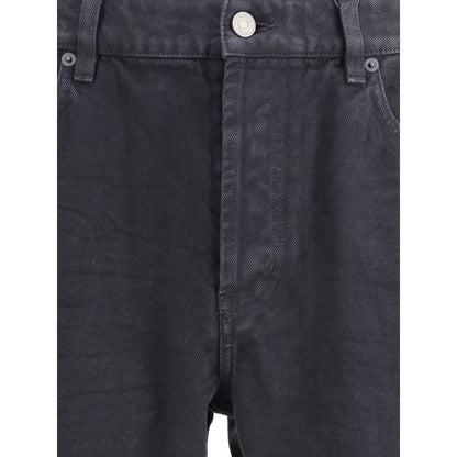 Close-up of Saint Laurent Black Cotton Straight-Leg Jeans showcasing front zipper and button closure.