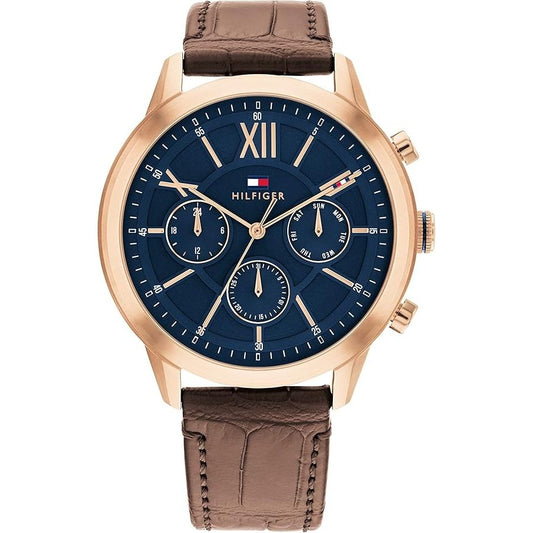 TOMMY HILFIGER Mod. 1710526 men's quartz analog watch with brown leather bracelet, 44mm mineral dial, gold-tone case, and official packaging.