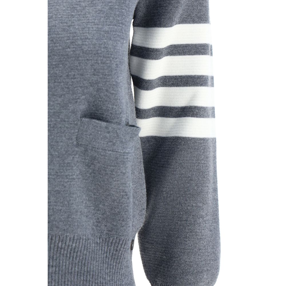 Close-up of Thom Browne Gray Fleece Wool Cardigan featuring contrasting stripes on arm, open pocket, and ribbed cuffs.