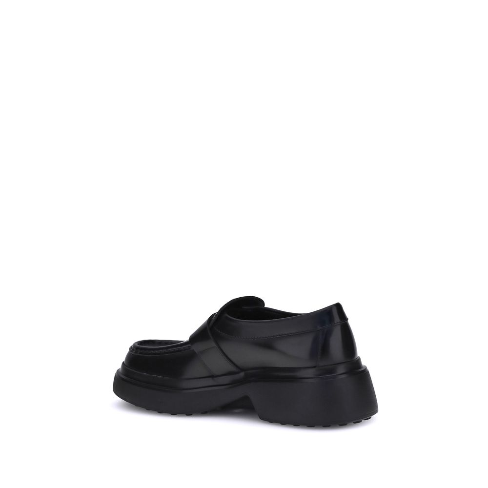 Rear view of Tod's Black Rubber Platform Loafers showcasing contemporary platform sole design.