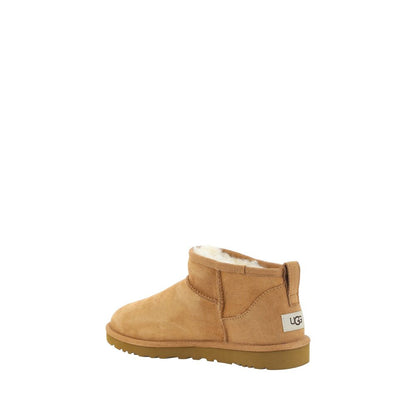 UGG Brown Goatskin Ankle Boots with shearling lining, knurled sole, round toe, and suede design showcasing iconic monogram on heel.