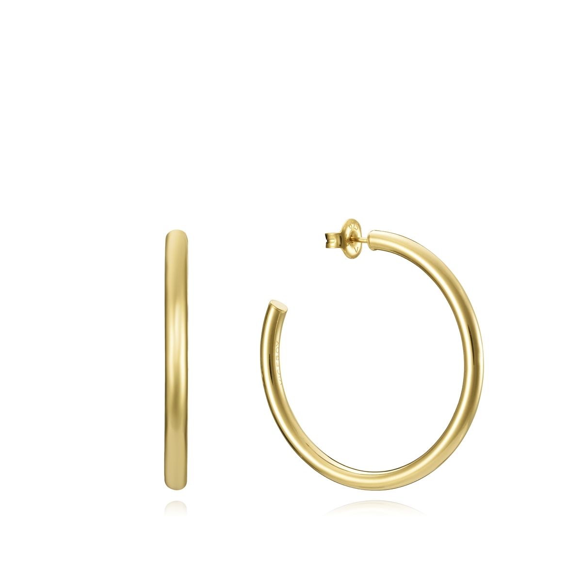 Gold hoop earrings with a minimalist design, highlighting the elegance of simple luxury jewelry.