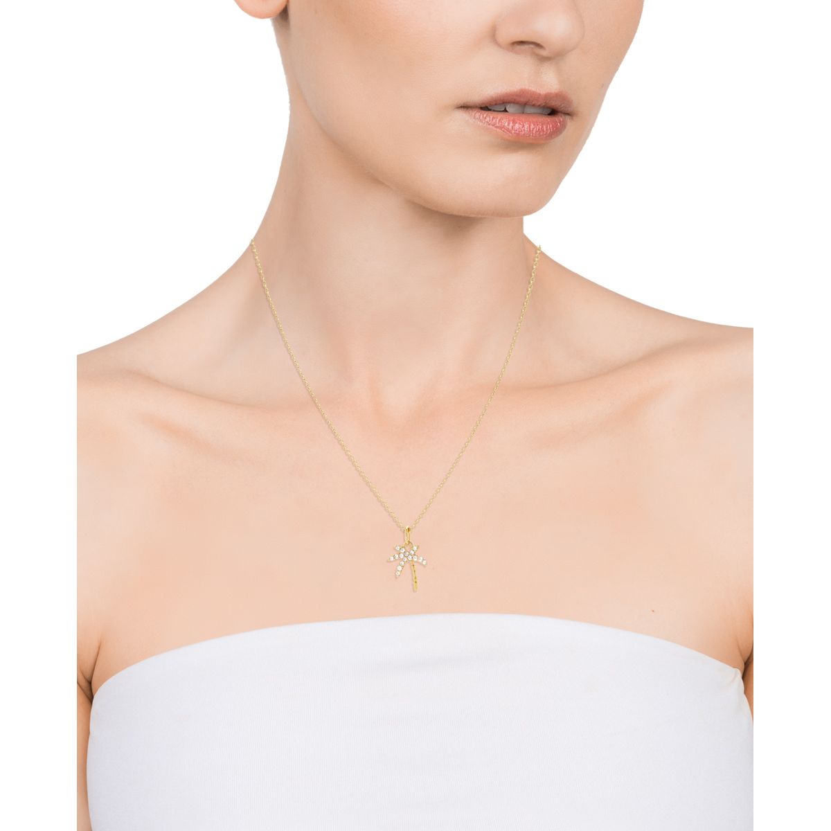 Woman wearing a delicate gold necklace with a star pendant, showcasing elegant jewelry fashion.
